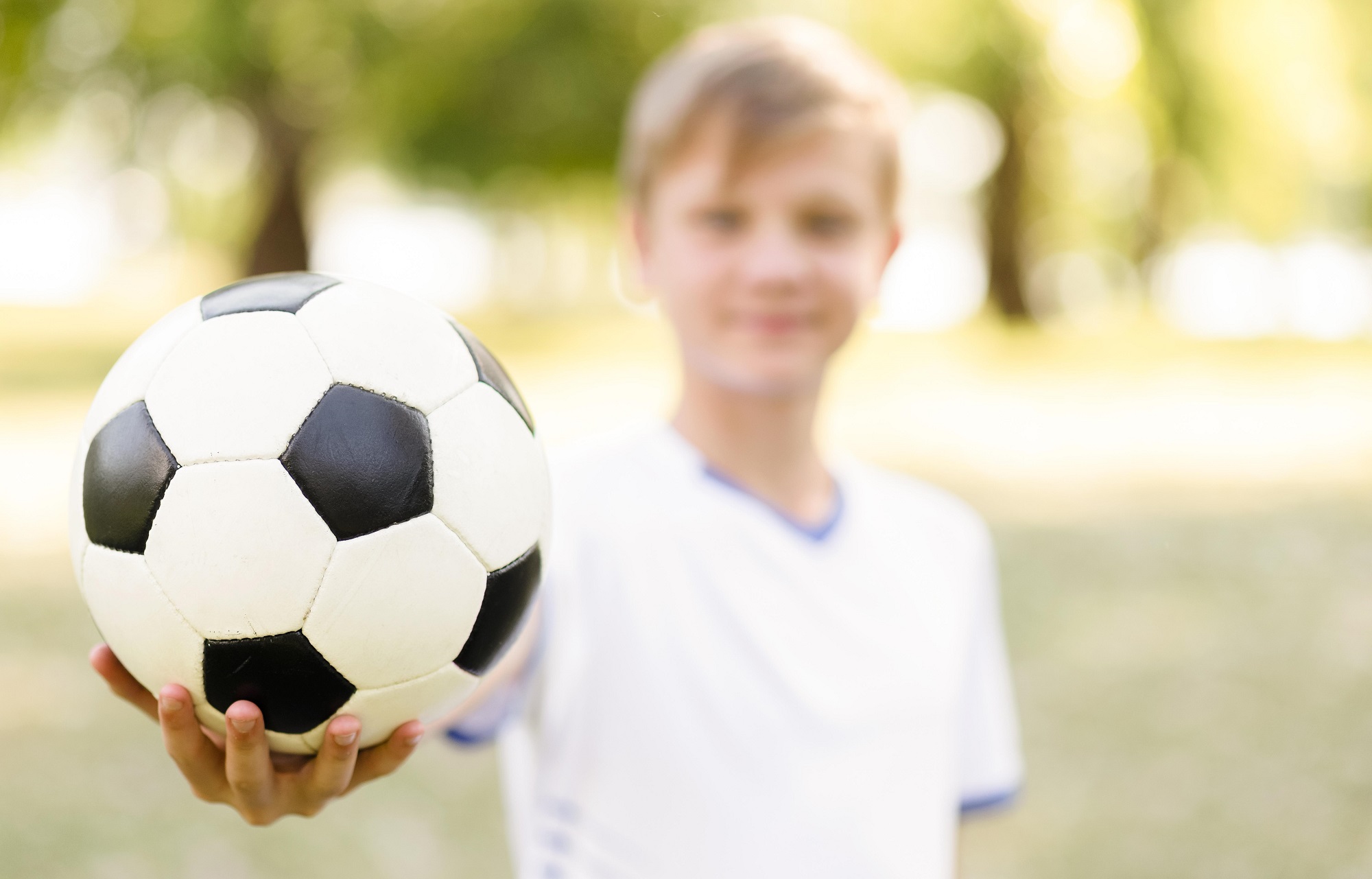 unfocused-blonde-boy-holding-football